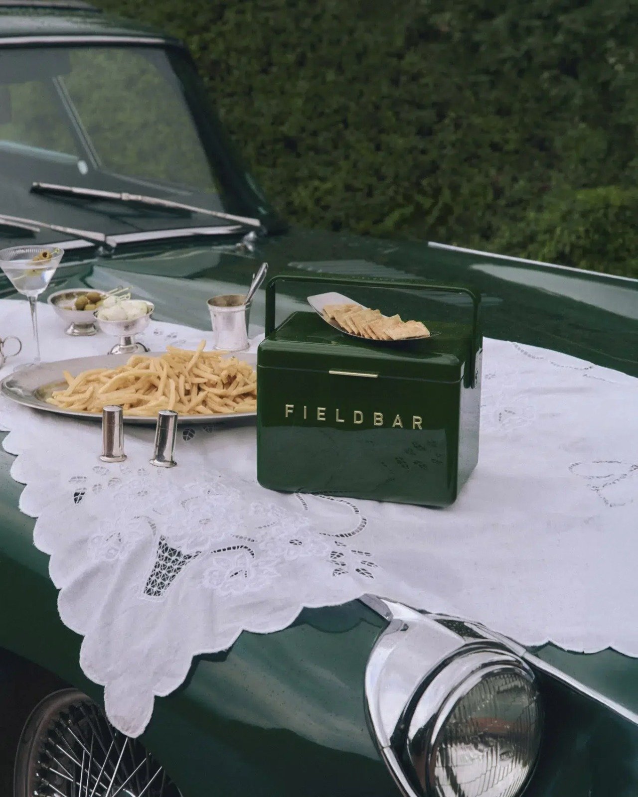 Fieldbar Racing Green gin trunk on a car bonnet with champagne